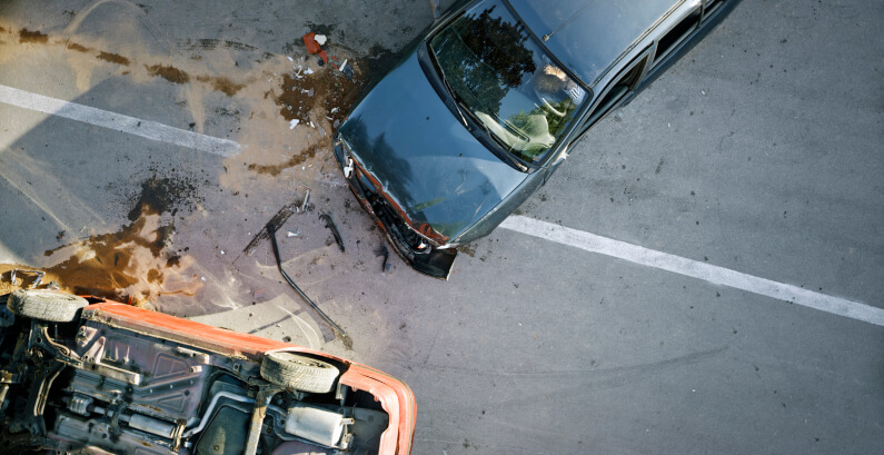 A car turned upside down in street after a car accident