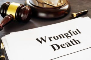 paper with words written wrongful death laying on desk in front of law gavel