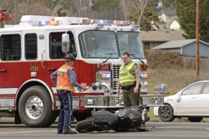 ROSEBURG, OR, USA - JANUARY 13, 2014: Emergeny responders at the scene of a motorcycle vs car at a busy intersection that left the rider with serious injuries.