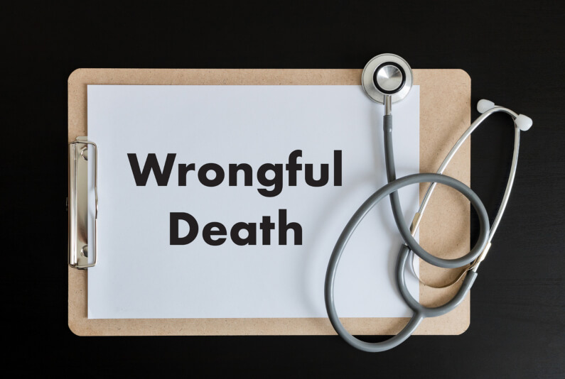 Stethoscope with a piece of paper that says wrongful death