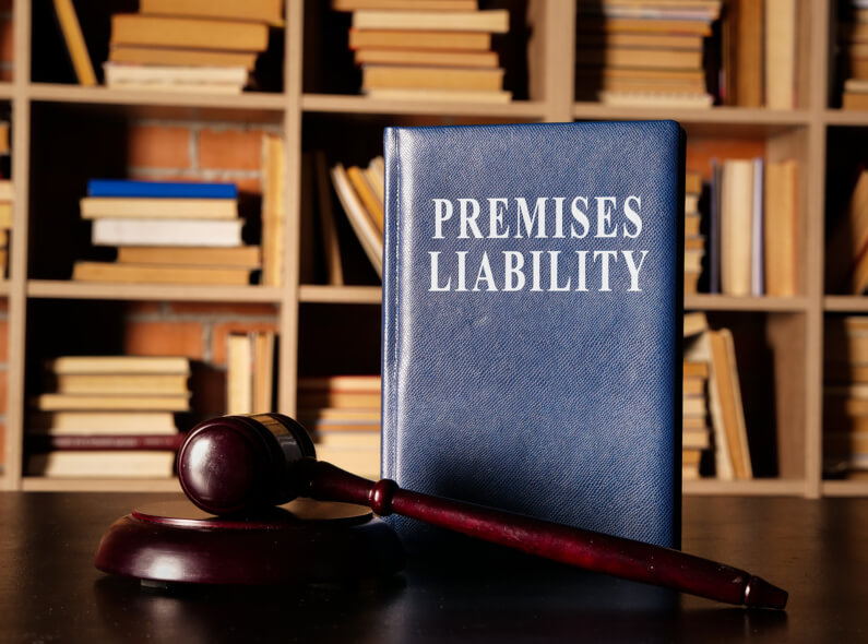 law gavel on table in front of a law book that says Premises Liability